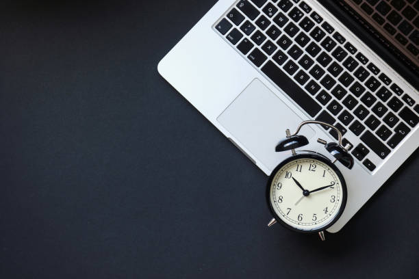 istock Black alarm clock on laptop 835254114