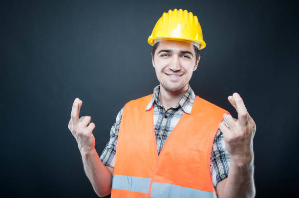 istock Constructor wearing equipment showing double fingers crossed gesture 835261472