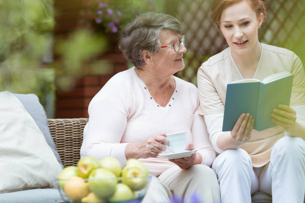 istock Nurse reading to pensioner 835268992