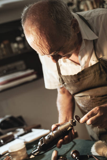 istock Senior entrepreneur working with grinder in instrument shop 835270198