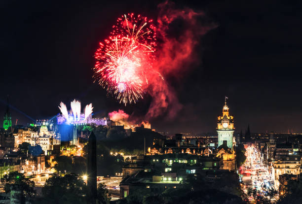 Fireworks over Edinburgh's skyline Fireworks exploding over the city of Edinburgh, photographed from Calton Hill, with the traffic of Princes Street visible towards the right. hogmanay photos stock pictures, royalty-free photos & images