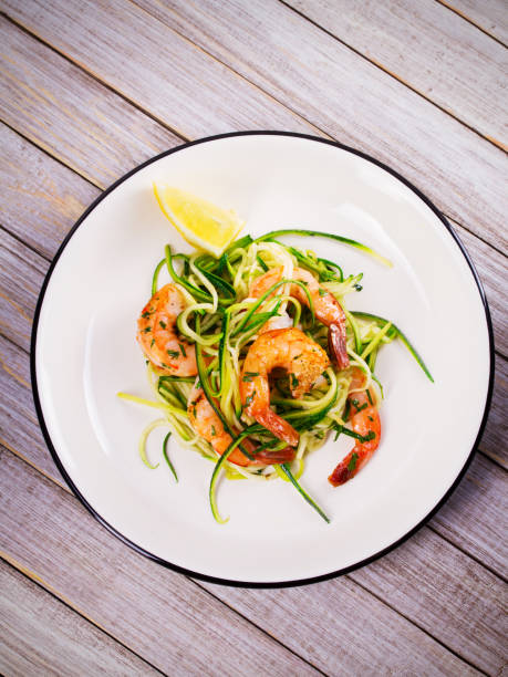 istock Shrimp with zucchini noodles. Prawns with vegetables and lemon 835285472