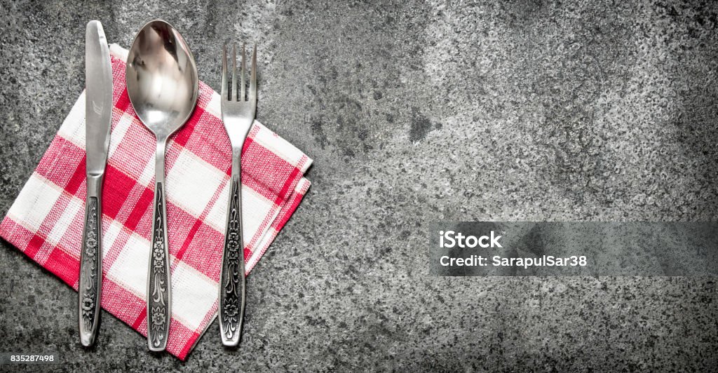 Serving background. Cutlery on a napkin. Serving background. Cutlery on a napkin. On rustic background. Antique Stock Photo