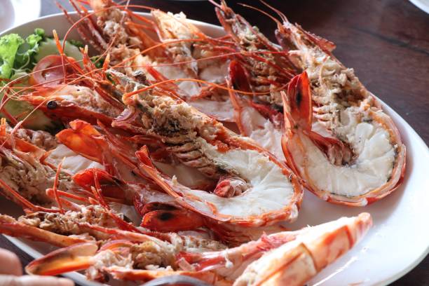 istock Half baked shrimp seafood split on white dish 835319260