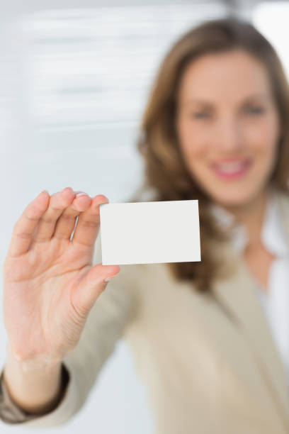 istock Smiling businesswoman holding blank card 835330400