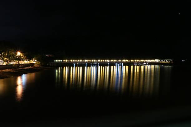 istock The night light at the bridge reflection on the beach 835340348