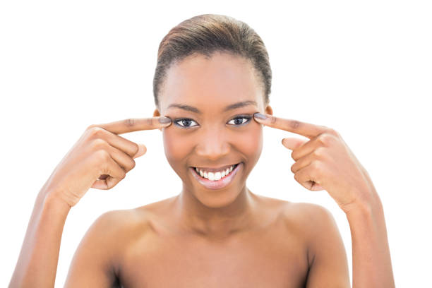 istock Smiling beautiful model pointing at her eyes 835342092