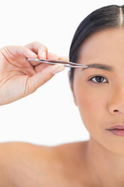 istock Half face of natural woman using tweezers 835349198