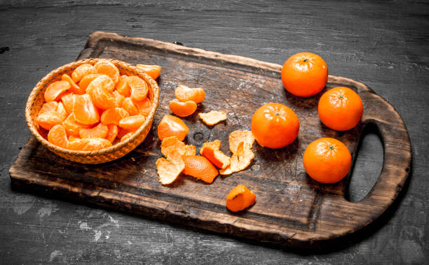 istock Peeled tangerines with green leaves. 835351626
