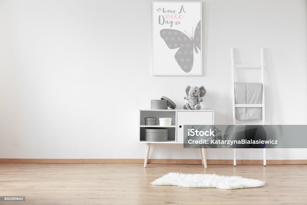 Cupboard with boxes White wooden cupboard with round cardboard boxes and fluffy rug in the room Carpet - Decor Stock Photo