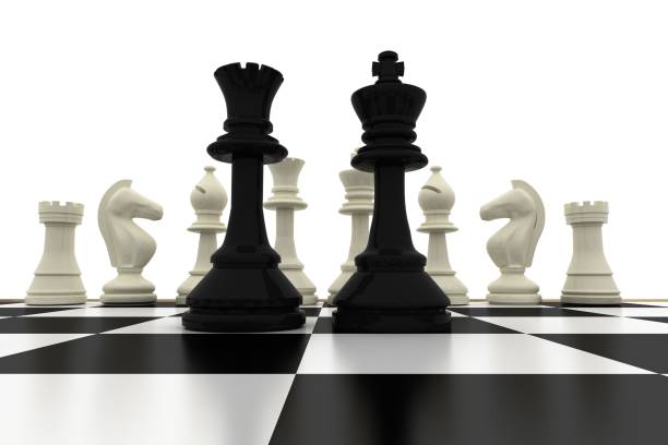 istock Black king and queen standing in front of white pieces 835362786
