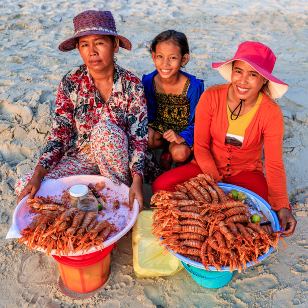 Cambodian women selling fresh lobsters on the beach, Sihanoukville, Cambodia Happy Cambodian women selling fresh lobsters on the beach, Sihanoukville, Cambodia cambodian ethnicity stock pictures, royalty-free photos & images