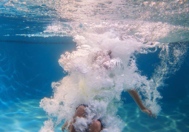 istock Teen jumping on a pool 835378168
