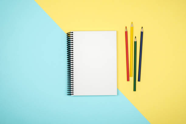 istock Top view of open spiral blank notebook on colorful desk background 835386548