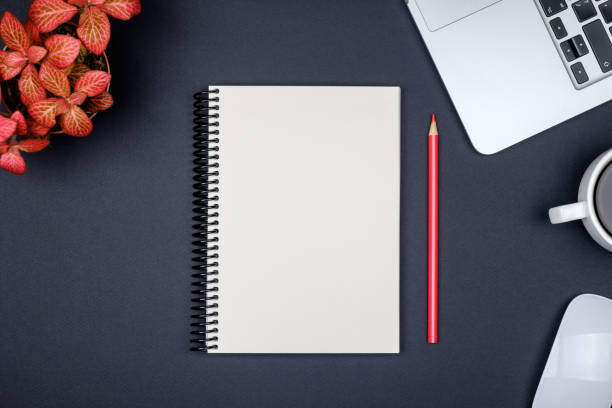 istock Modern black office desk table with laptop and blank notebook page for input the text. Top view, flat lay 835388808