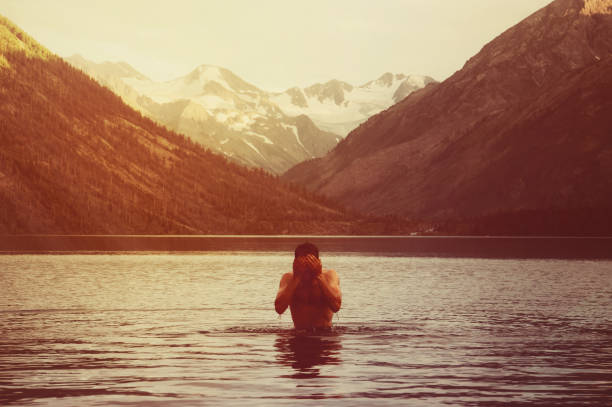 istock Taking breath swimming butterfly in lake at sunset. 835389666