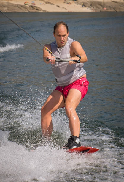 istock Funny wake-boarding sport on the lake 835394240