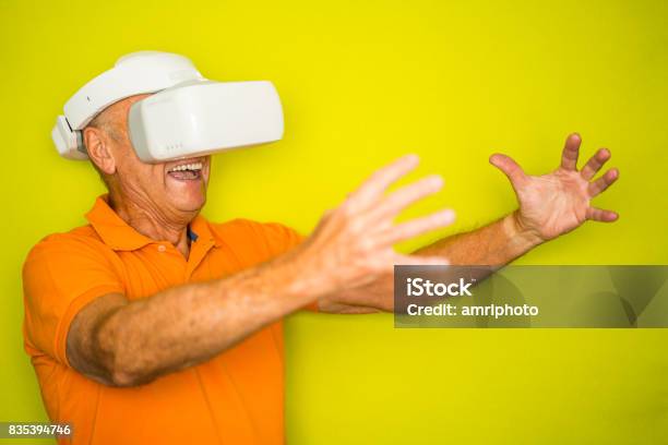 Color Surge For Stylish Seniors Senior Man With Vr Googles And Outstretched Arms Stock Photo - Download Image Now
