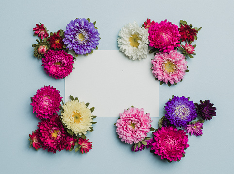 Creative flower arrangement frame with paper note. Place for text.