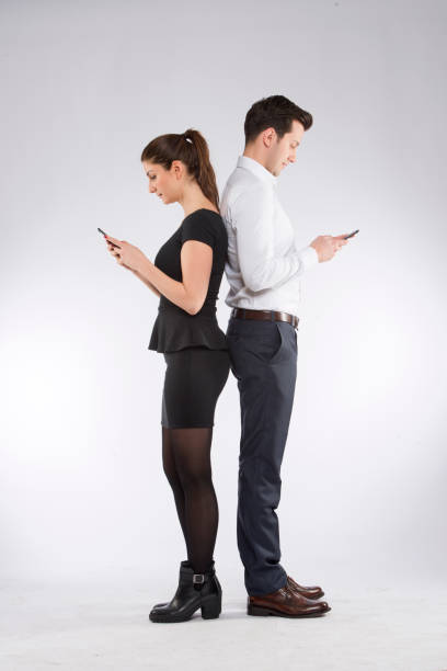 istock A man and a woman texting back to back 835407006