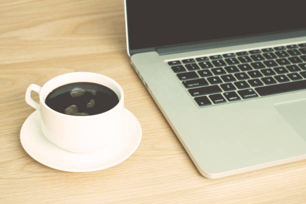 istock hot black coffee with laptop 835407860