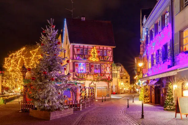 Traditional old half-timbered houses in the historic city of Colmar. Decorated and lighted during the Christmas season. Alsace. France.