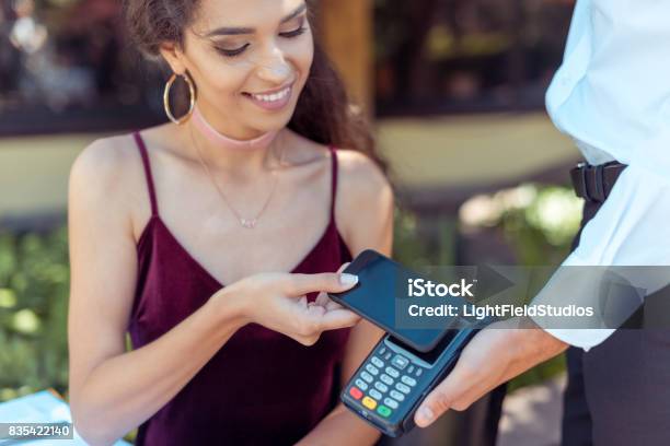 Woman Paying With Nfc Technology Stock Photo - Download Image Now - Checkout, Mobile Phone, Paying
