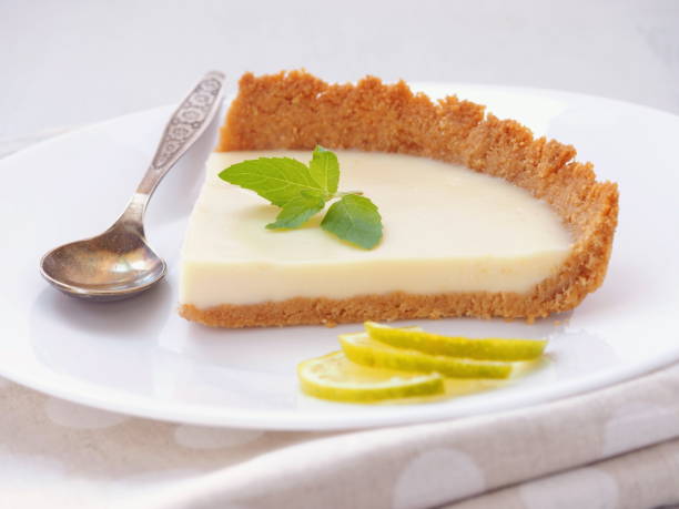 Coffee cake decorated with lime slices and fresh mint. Homemade lemon pudding. stock photo
