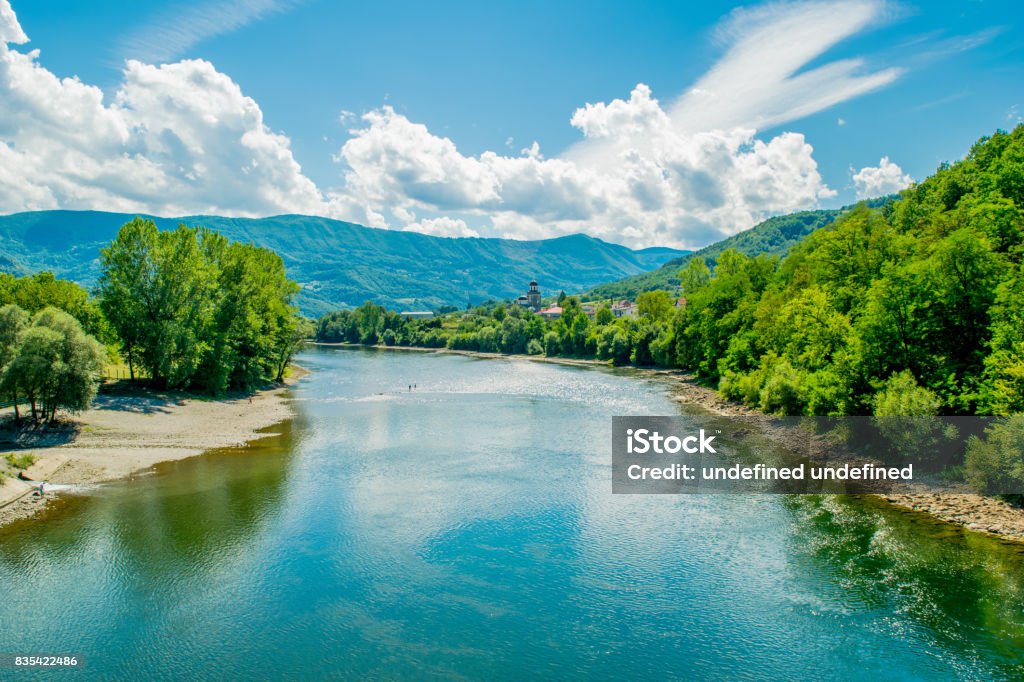 Majestic look to the Drina River in Serbia. Beautiful landscape include sky, clouds, mountains, river, forest, stone coast and reflection. Beauty Stock Photo