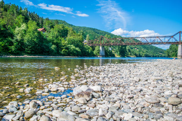 istock Rusty bridge and stone river coast in the afternoon. 835422588