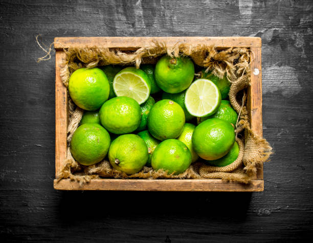 istock Fresh limes in the old box. 835422712