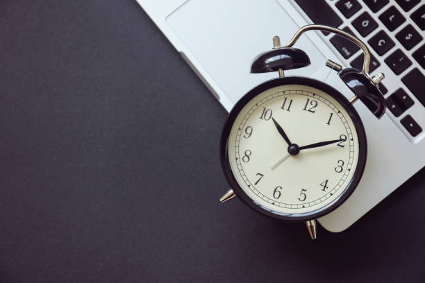 Black alarm clock on laptop