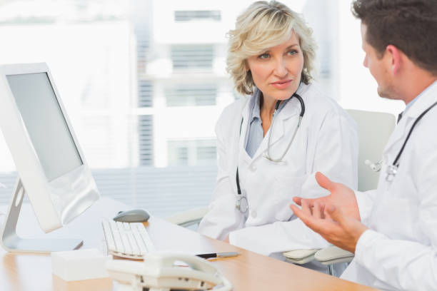 istock Doctors in discussion at medical office 835429680