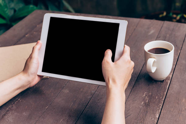 istock Asian woman using tablet on table in coffee shop with vintage toned. 835444082