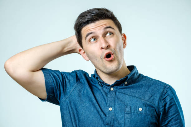 istock Portrait of a young beautiful man with surprised face expression over gray 835444264