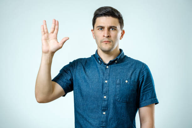 Vulcan greeting. Vulcan Salute. Man welcomes fans of fiction films Vulcan greeting. Vulcan Salute. Man welcomes fans of fiction films vulcan salute stock pictures, royalty-free photos & images