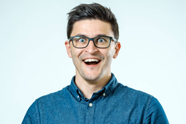 istock Portrait of a young beautiful man with surprised face expression over gray 835444320