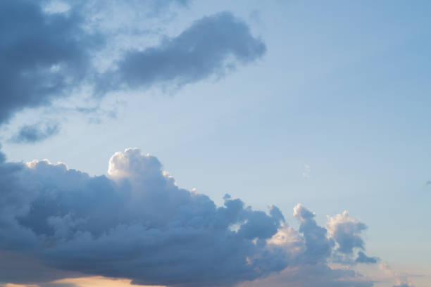 istock Grey and blue fkuffy clouds on the light-blue sky at sunset or sunrise 835447656