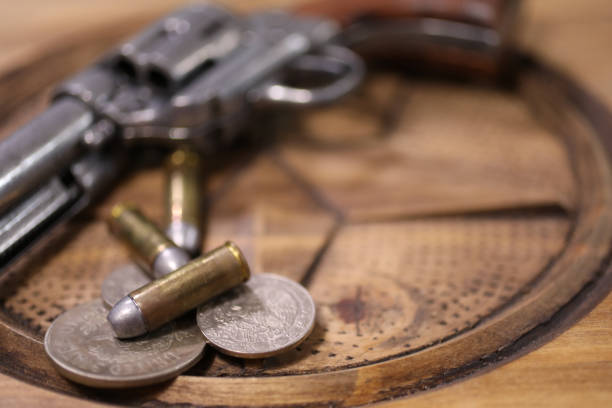 Old clock and ammunition on a white table. Explosive material and time measure. Light background.