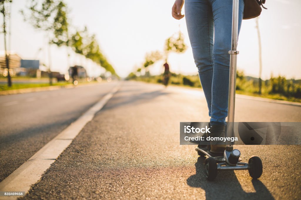 Close-up of woman riding push scooter Effortless Stock Photo