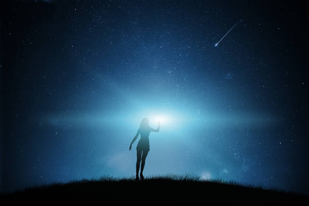 Woman silhouette with night sky.