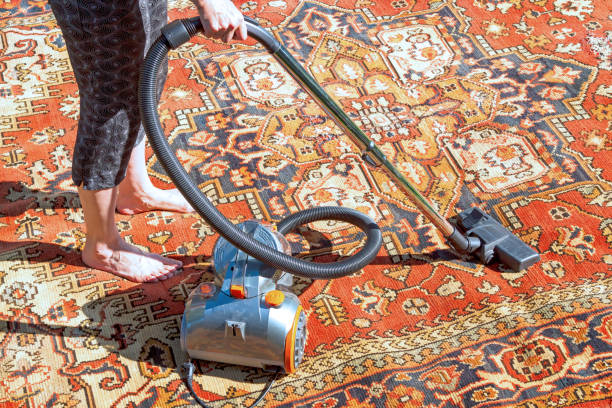 istock Woman vacuums an old carpet 835470912
