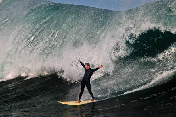 surfer świętuje jazdę na dużej fali - big wave surfing zdjęcia i obrazy z banku zdjęć