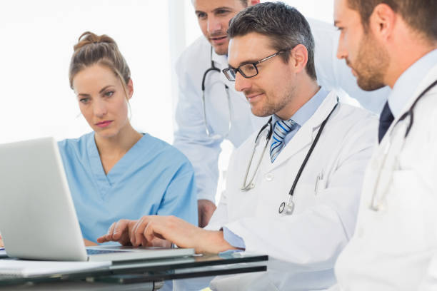 istock Group of concentrated doctors using laptop 835493630