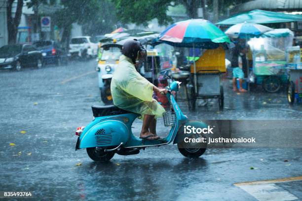 Thai On Motorcycle At Heavy Rain Stock Photo - Download Image Now - Rain, Bangkok, Thailand