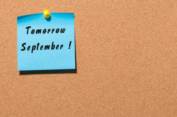 istock Tomorrow September written on a sticker at notice board with empty space for text 835507888