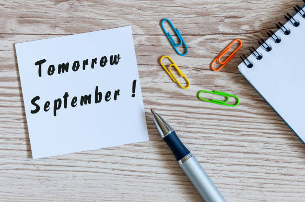 istock September tomorrow word wrote on white paper school desk background. Back to school time. Top view 835508130