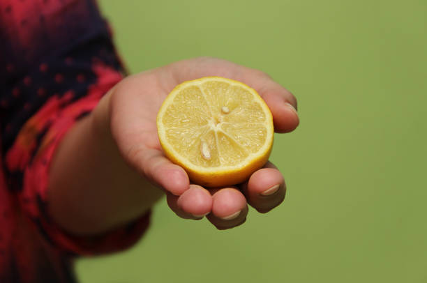 Lemon in hand stock photo