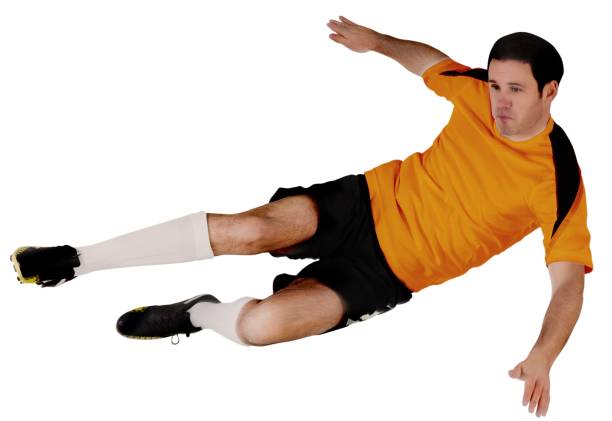 istock Football player in orange kicking 835522052