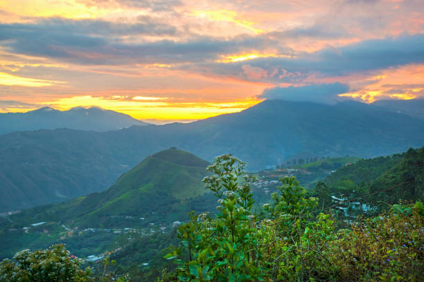 View of a mountain range, foreground plants and bushes with a beautiful sunset sky in the background. Zaruma, El Oro, Ecuador.
